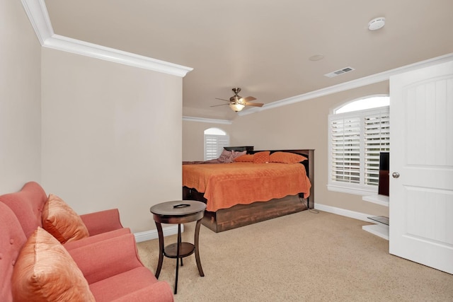 bedroom featuring ceiling fan, ornamental molding, light carpet, and multiple windows