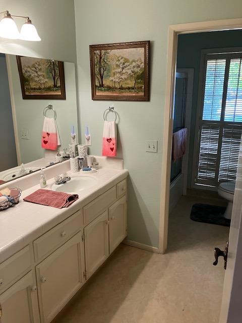 bathroom featuring vanity and toilet