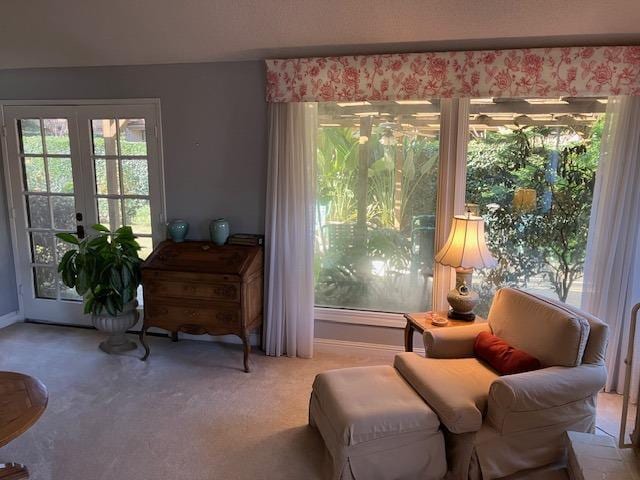 sitting room featuring french doors and carpet