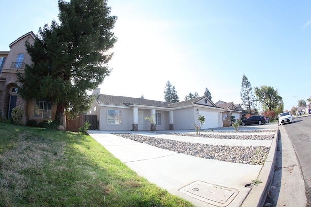 ranch-style house featuring a garage and a front lawn