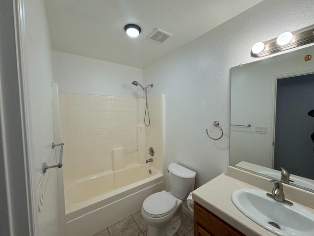 full bathroom featuring tile patterned flooring, shower / bathing tub combination, a textured ceiling, toilet, and vanity