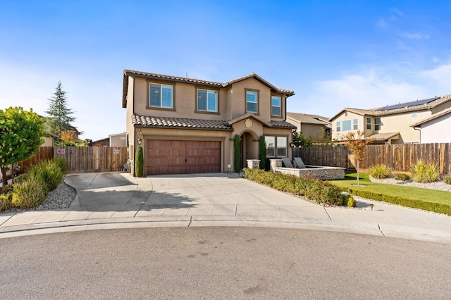 view of front of house with driveway, a tile roof, fence, and stucco siding