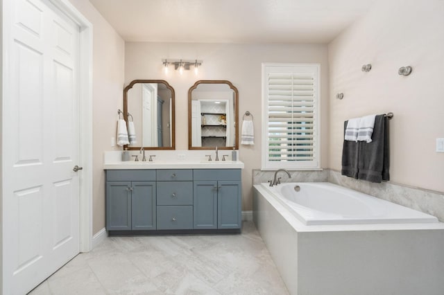 bathroom with double vanity, a sink, and a bath