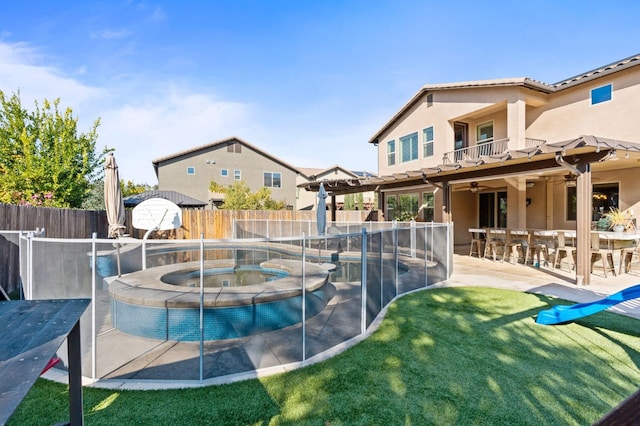 view of pool with a fenced backyard, an in ground hot tub, a ceiling fan, outdoor dry bar, and a fenced in pool