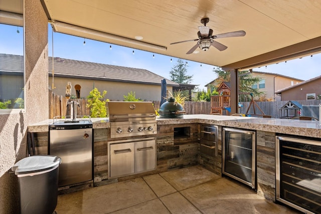 view of patio / terrace with beverage cooler, a grill, area for grilling, and fence