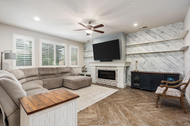 living area with recessed lighting, a fireplace, visible vents, and a ceiling fan