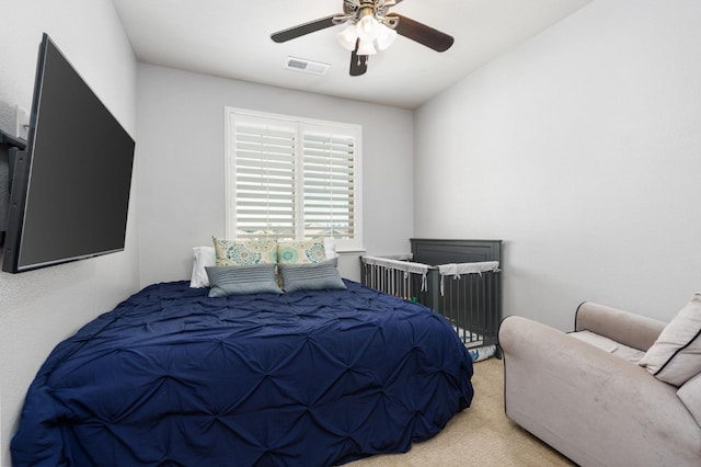 bedroom with carpet floors, visible vents, and a ceiling fan