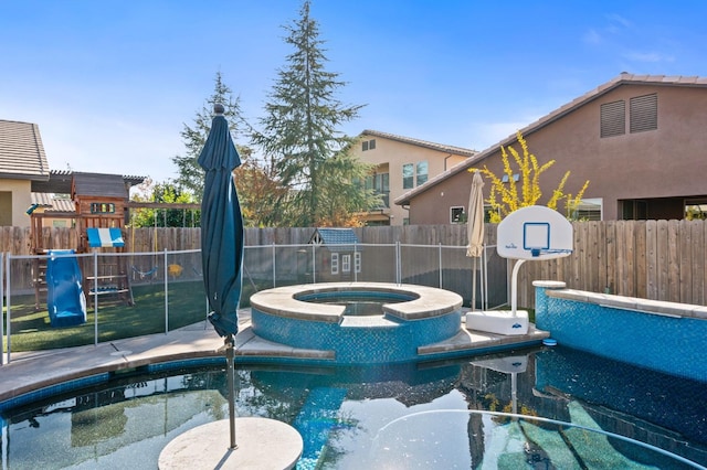 view of swimming pool featuring an in ground hot tub, a playground, and a fenced backyard