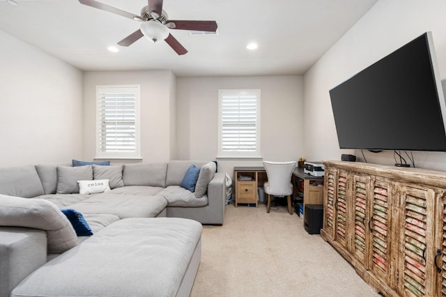 living area with light carpet, a ceiling fan, and recessed lighting