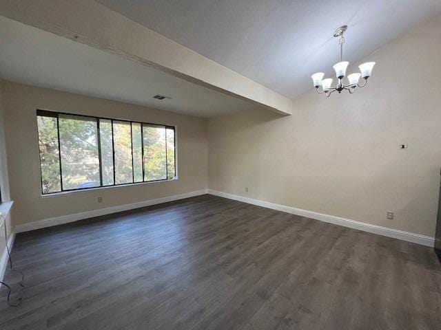 spare room featuring vaulted ceiling with beams, dark hardwood / wood-style flooring, and an inviting chandelier