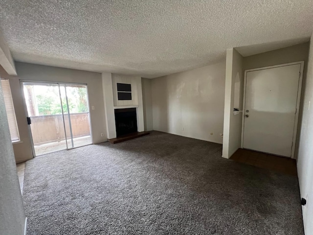 unfurnished living room featuring carpet floors and a textured ceiling