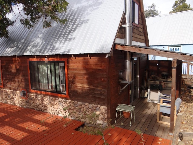 view of property exterior with a wooden deck