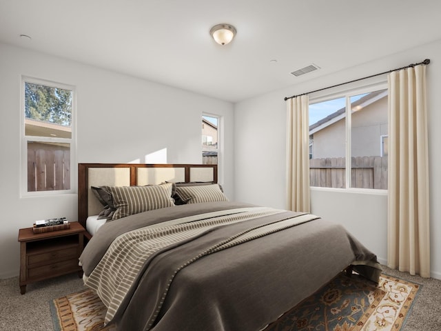 bedroom featuring multiple windows and carpet floors