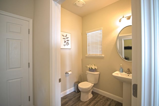 bathroom featuring sink, wood-type flooring, and toilet