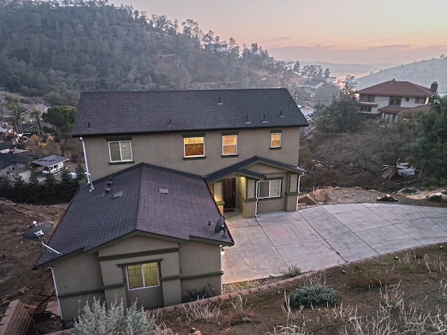 view of back house at dusk