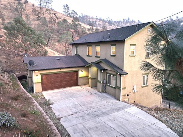 front of property featuring a mountain view and a garage