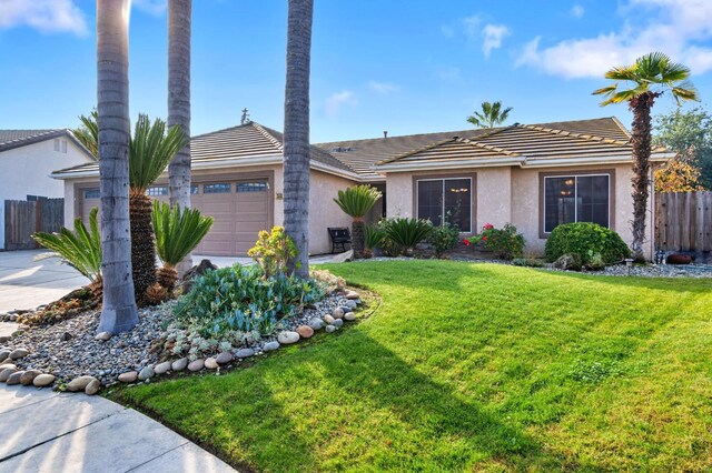 single story home featuring a garage and a front yard