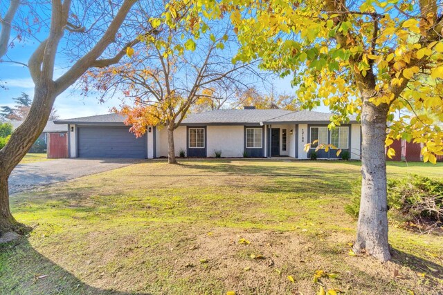 single story home with a front yard and a garage