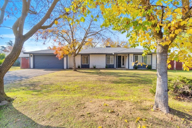 ranch-style home with a garage and a front lawn