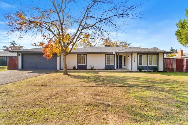 ranch-style home featuring a front yard and a garage