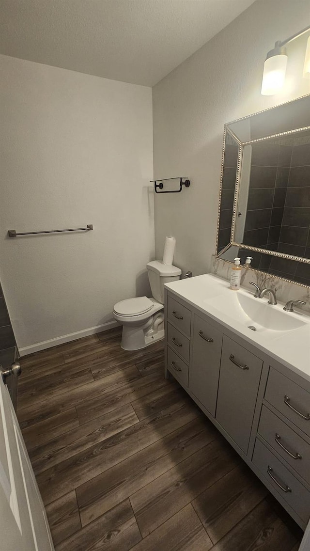 bathroom featuring vanity, toilet, and wood-type flooring