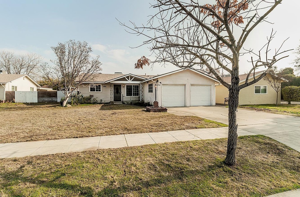 single story home featuring a front yard and a garage