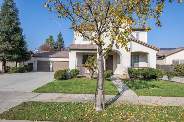 mediterranean / spanish house featuring a porch, a front yard, and a garage