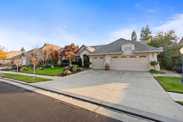 single story home with a front lawn and a garage