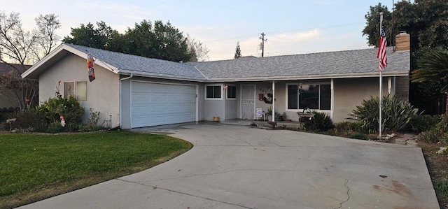 single story home featuring stucco siding, driveway, a front yard, and a garage