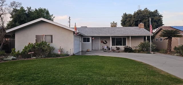 ranch-style house featuring a garage and a front yard