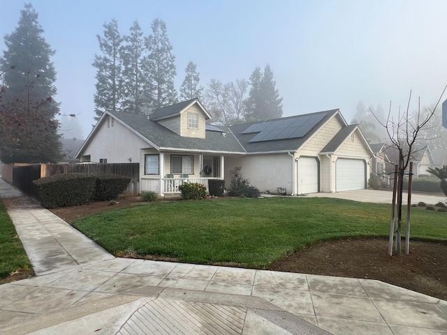 view of front facade featuring solar panels, a porch, a front lawn, and a garage