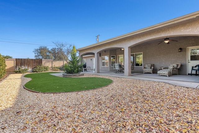 back of house featuring ceiling fan and a patio area