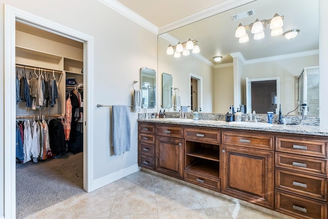 bathroom featuring crown molding, tile patterned floors, and vanity