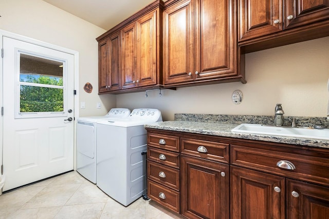 laundry area with cabinets, sink, separate washer and dryer, and light tile patterned flooring