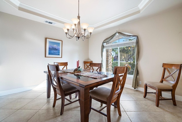 dining area with a raised ceiling, light tile patterned floors, crown molding, and an inviting chandelier