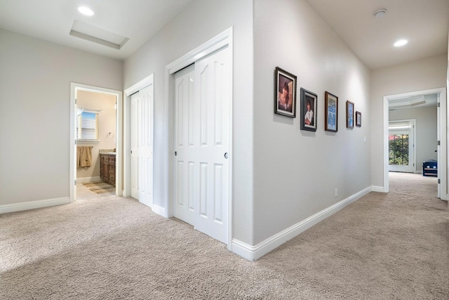 corridor with light colored carpet