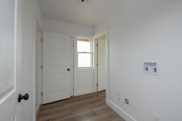 laundry area with hookup for a washing machine and light hardwood / wood-style flooring