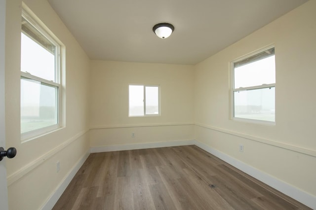 unfurnished room featuring hardwood / wood-style floors