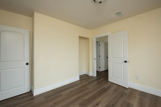 spare room featuring dark hardwood / wood-style flooring