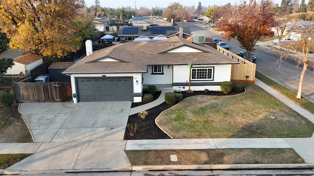 ranch-style home with a garage and a front yard