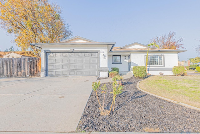 single story home featuring a garage and a front lawn