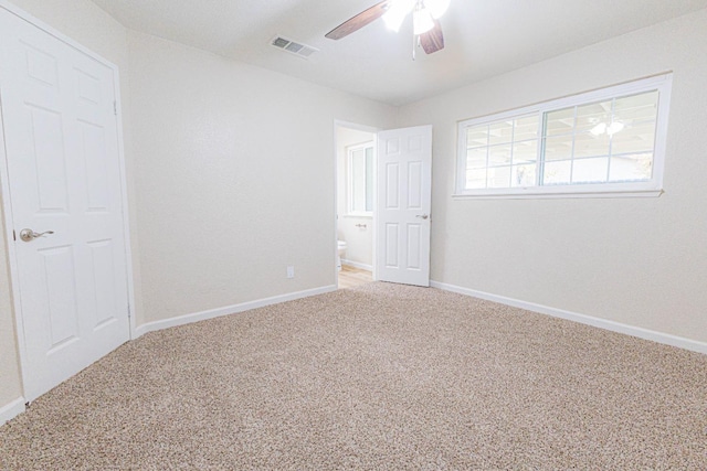 carpeted spare room featuring ceiling fan