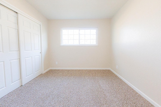 unfurnished bedroom with a closet and carpet