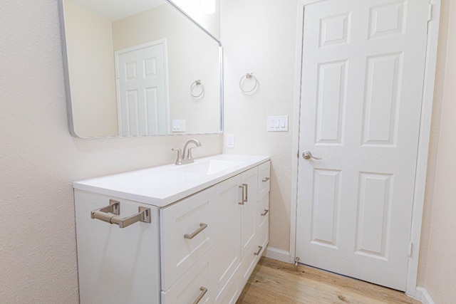 bathroom featuring hardwood / wood-style flooring and vanity