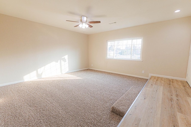 spare room with light hardwood / wood-style floors and ceiling fan