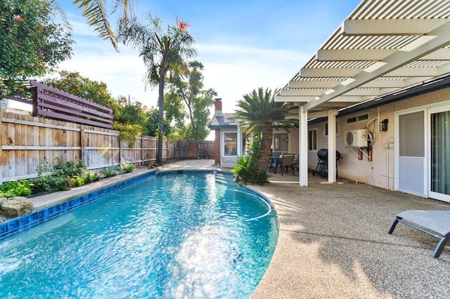 view of pool with a pergola, a patio area, and grilling area