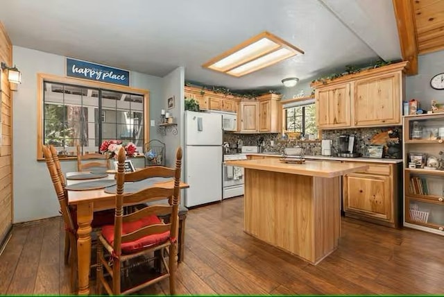 kitchen with white appliances, backsplash, dark wood-type flooring, light brown cabinetry, and a kitchen island