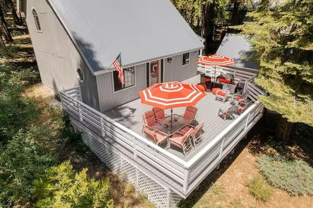 rear view of house featuring a wooden deck