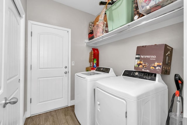 laundry room featuring hardwood / wood-style flooring and washer and clothes dryer