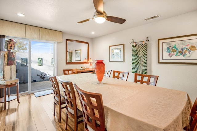 dining space featuring ceiling fan and light hardwood / wood-style flooring